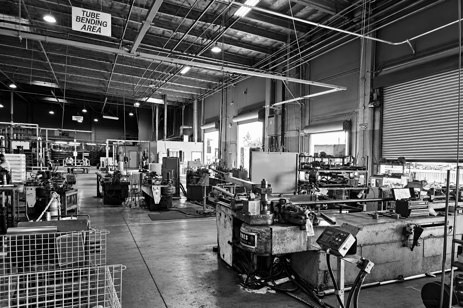 High contrast black and white view of PTB's tube bending area and bending equipment.